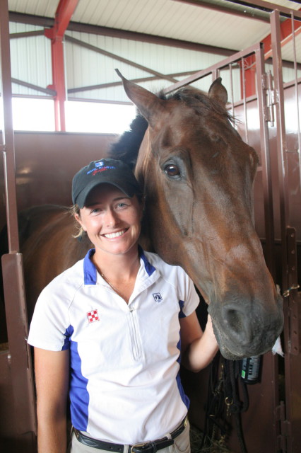 Julie Wolfert of Bucyrus, Kansas stands beside her 11-year-old Canadian Sport Horse, Getaway. They took home first place honors in the Open Novice division. She also placed second in the Novice Horse division on her thoroughbred, Buenas Suerte.