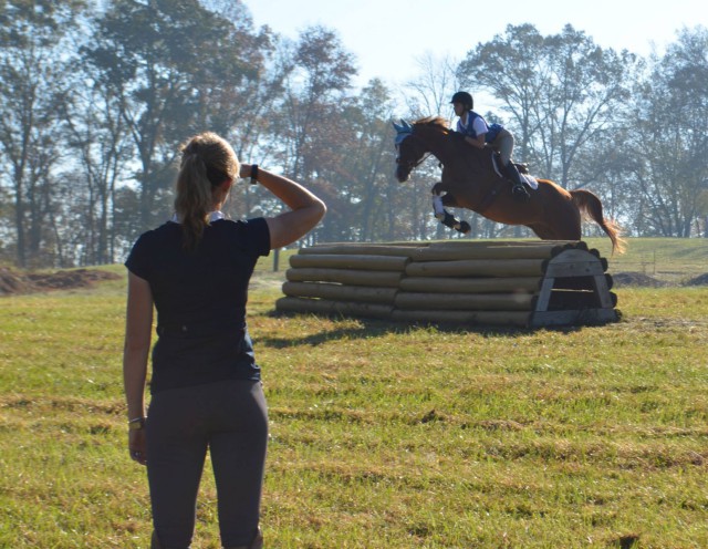 Sinead looks on as Shannon O'Hatnick and Solar Flare jump a roll top. Photo by Kaylen Moon.