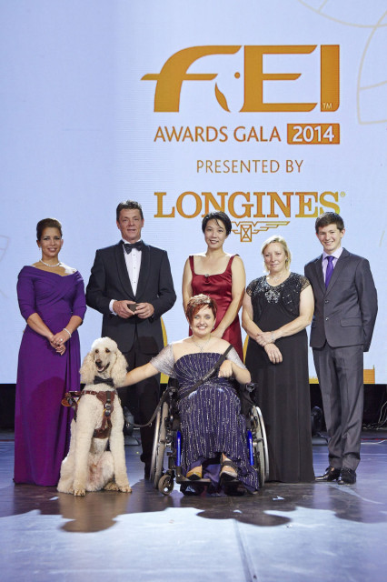 Equestrian heroes celebrated at the 2014 FEI Awards Gala presented by Longines. Left to right: HRH Princess Haya, Jeroen Dubbeldam (NED), Melissa Tan (SIN), Jackie Potts (GBR), Lambert Leclezio (MRI) with (centre) Sydney Collier (USA) and her service dog Journey. Photo by FEI/Liz Gregg