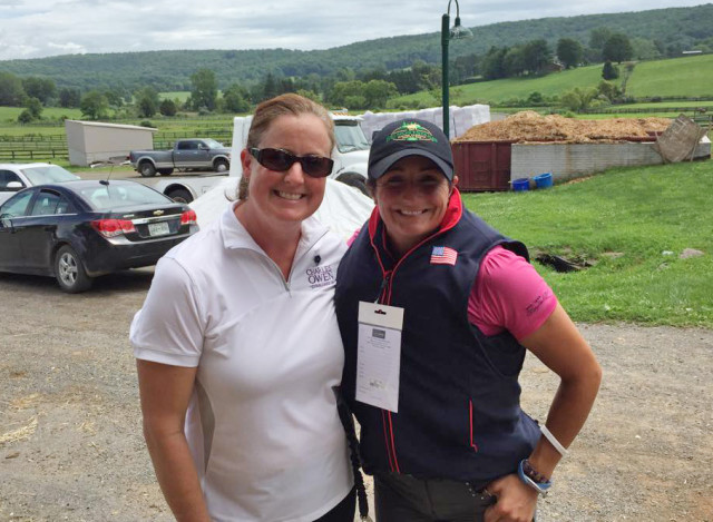 Danielle Santos helps Jennie Brannigan with the fit on her new team vest. Photo via Facebook.