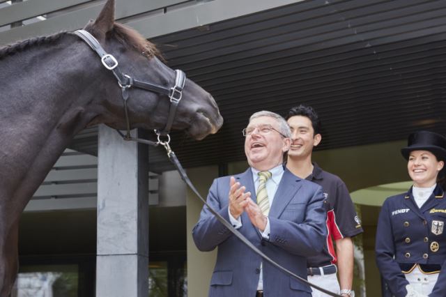 IOC President Thomas Bach was greeted at FEI Headquarters by the stallion Sarango after meetings with an FEI delegation headed by President Ingmar De Vos and Secretary General Sabrina Zeender. Also pictured are eventing athlete Alex Hua Tian (CHN) and German Dressage athlete Kristina Bröring-Sprehe. Photo by Liz Gregg/FEI.