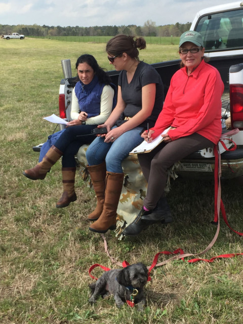 Susan Garbow (far right) volunteering at Pine Top Farm this spring with her dog, Teddy, Layton Moss (left) and Keeley Beckman (middle). Photo by Janet Wilson.